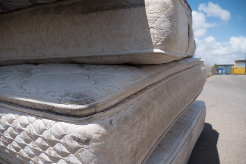 Filthy mattresses dumped at site.