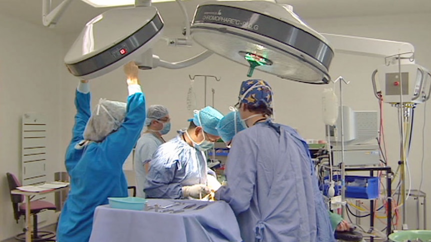 Video still: surgeons performing an operation in Canberra - generic
