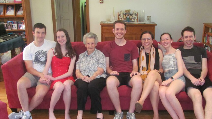 A seated family pose for a photo.