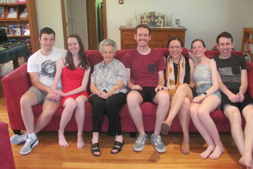 A seated family pose for a photo.