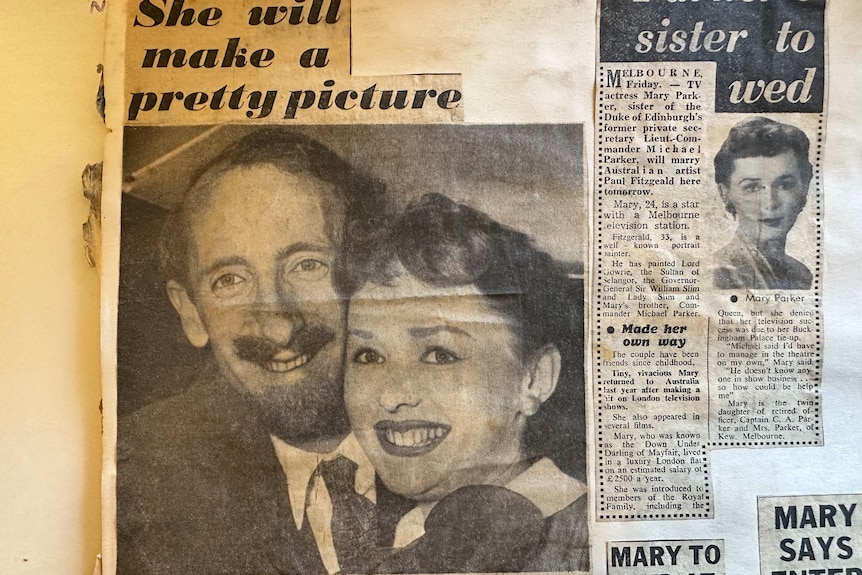 A newspaper clipping with a large picture of a man and woman smiling.
