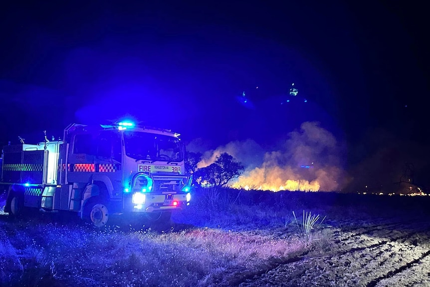 A CFS truck parked near the fire on the paddock. 