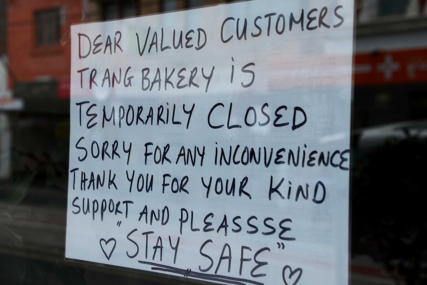 A sign on the window of Trang bakery saying that it is temporarily closed.