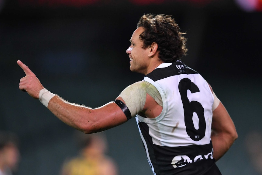 Steven Motlop of Port Adelaide is seen from behind as he points to celebrate a goal in the AFL showdown against Adelaide Crows.