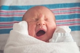Image of a baby yawning or crying