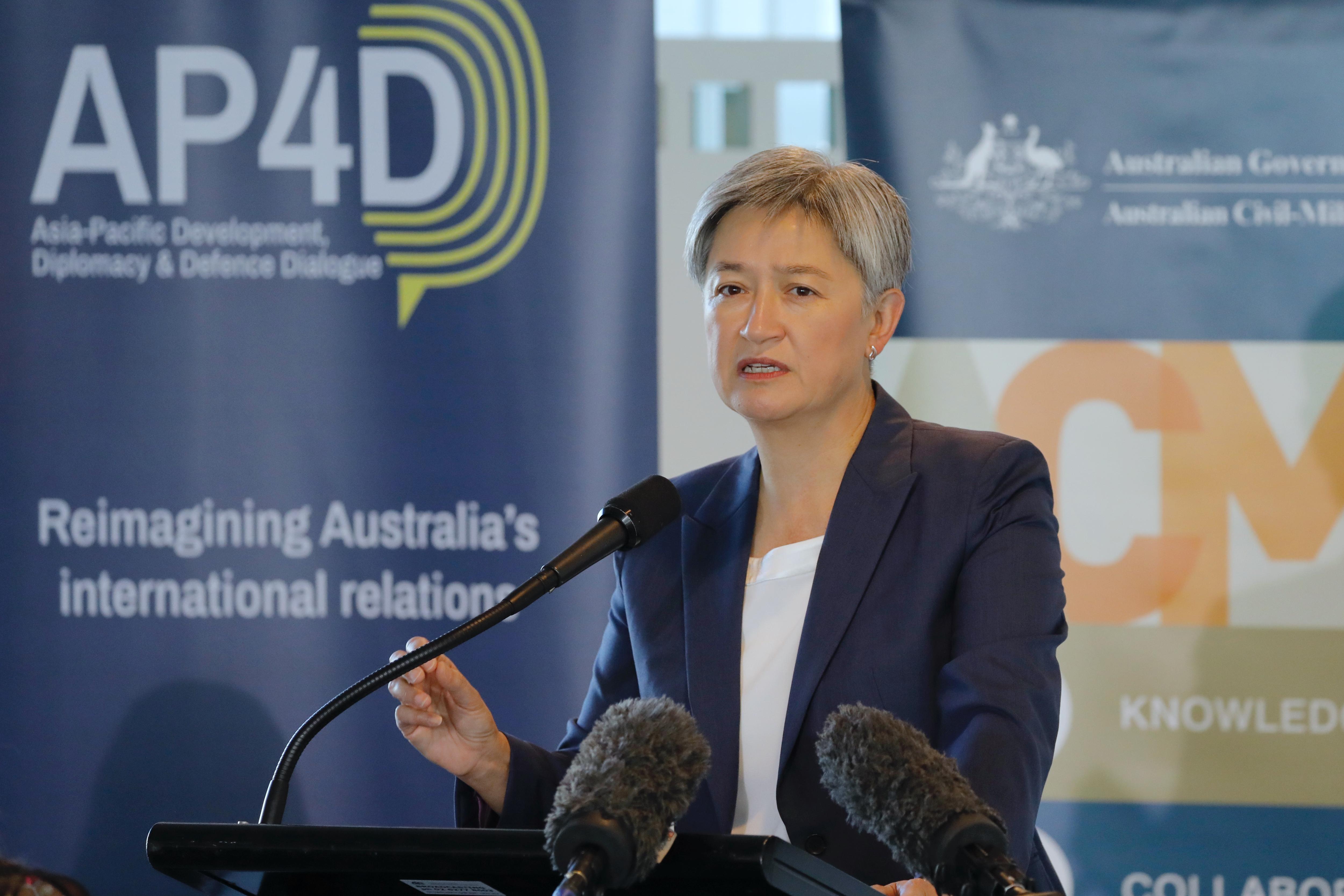 Penny Wong standing at a podium. 