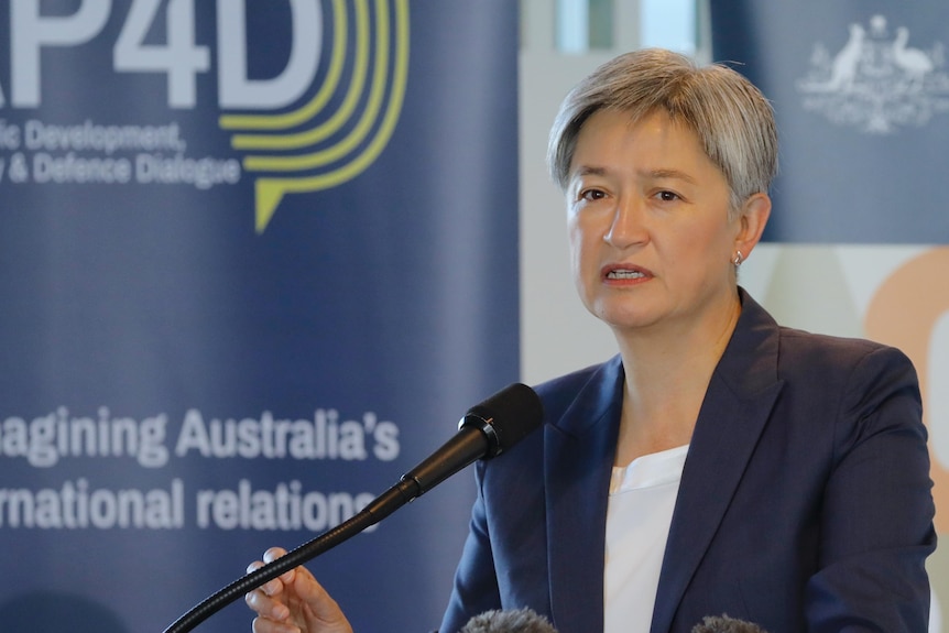 Penny Wong standing at a podium. 