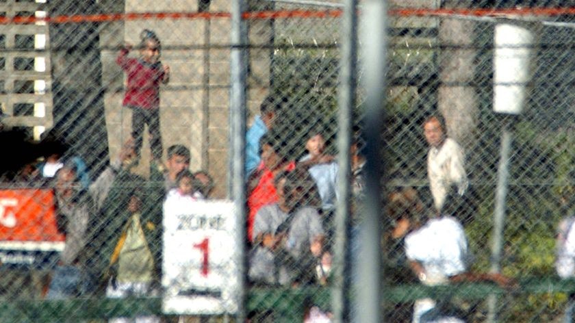 Detainees behind the fence