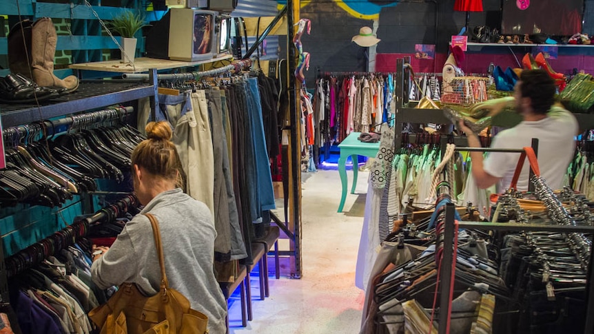 Clothes on racks inside the op shop.