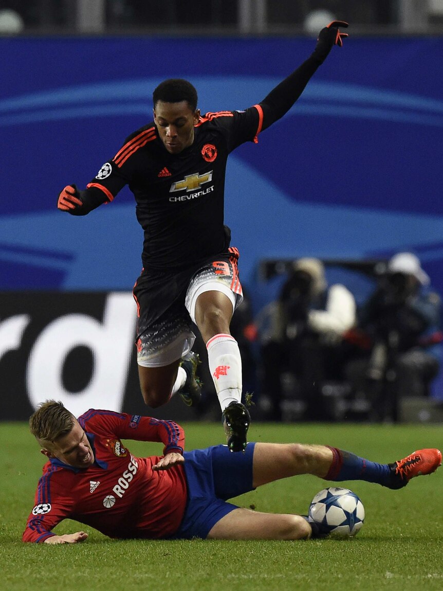 On the attack ... Manchester United's Anthony Martial jumps over the defence of Pontus Wernbloom