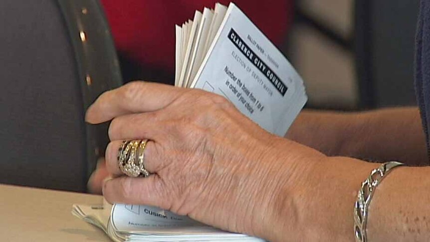 A woman counts local government ballot papers in Tasmania.