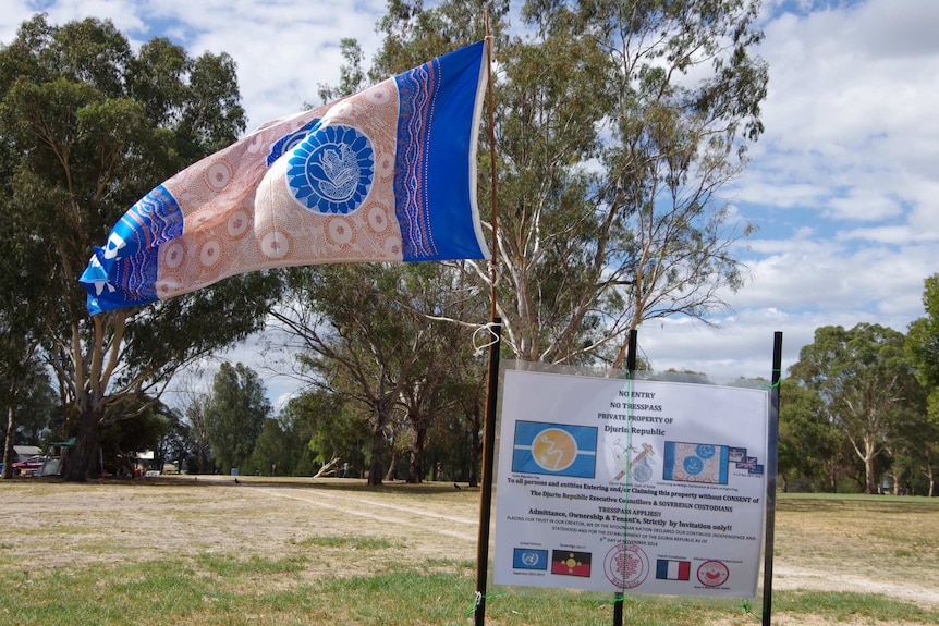 A flag and sign posted on Heirisson Island