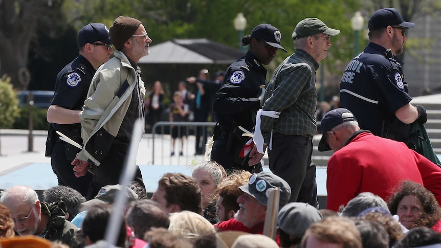 Protesters arrested and led away outside US Capitol.