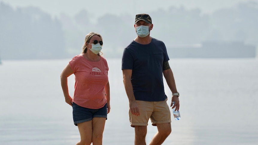 Couple walking amid the smoke on South Perth foreshore