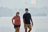 Couple walking amid the smoke on South Perth foreshore