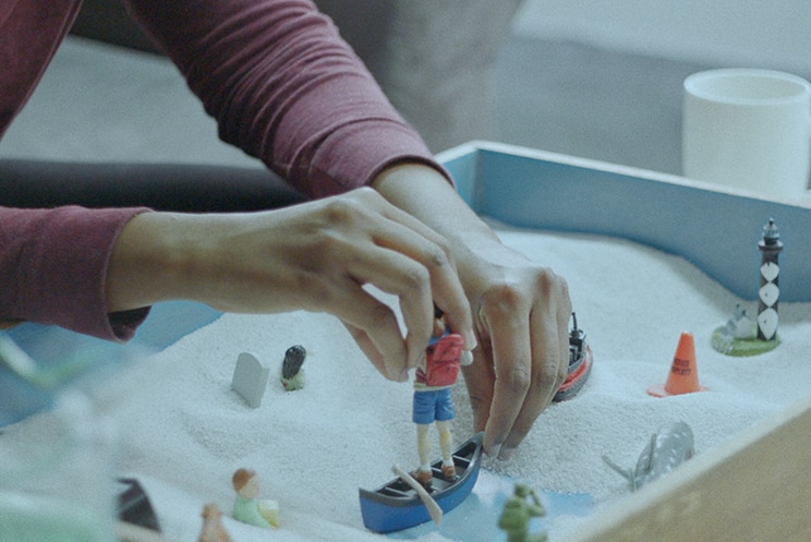 Colour still close-up of sandplay therapy from 2018 film Island of the Hungry Ghosts.