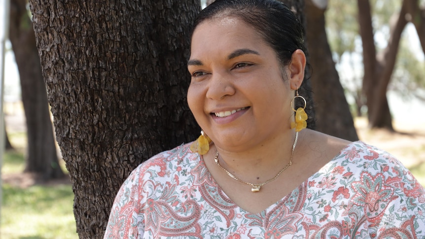 A portrait shot of an Aboriginal woman looking away from the camera. 