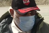 Narendra Modi wearing a hat and a facemask