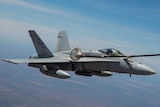 FA-18 Hornet refuels mid-air with KC-130