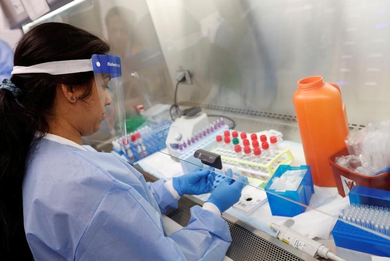 A medical technologist examining tests.