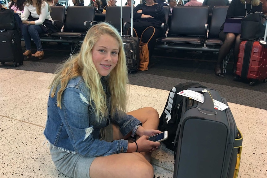 A girl sits on the floor