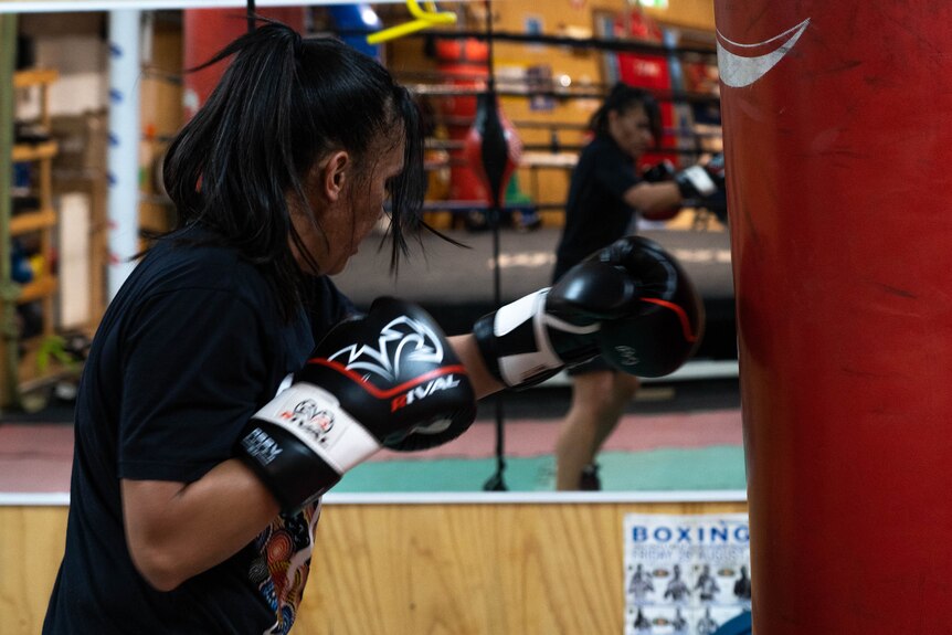 A woman boxing in a ring.
