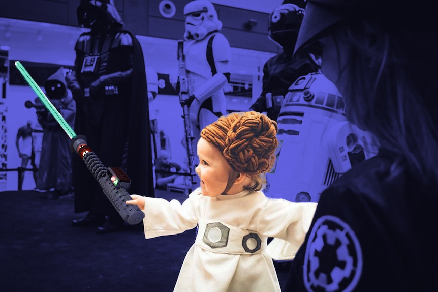 A little girl dressed as Princess Leia from Star Wars, with a blue lightsaber superimposed into her hand