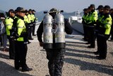 A diver walks to towards the water in the search for victims