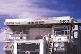 Mining trucks go about their work in the mines