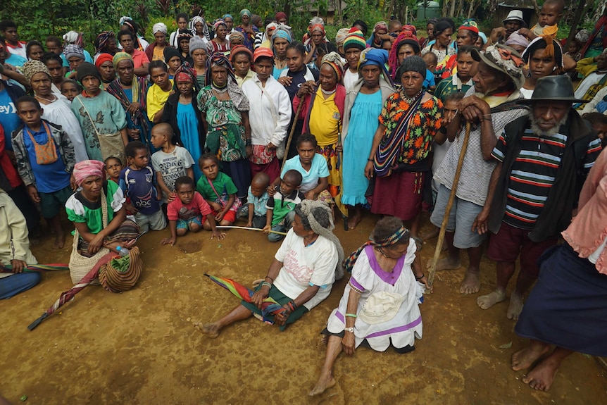 A group of displaced women and children stand together in Hoiebia village in PNG