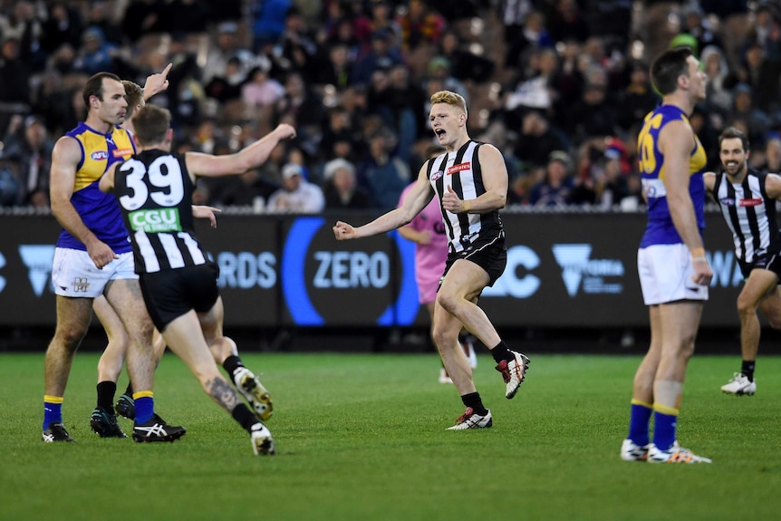 Adam Treloar celebrates a goal