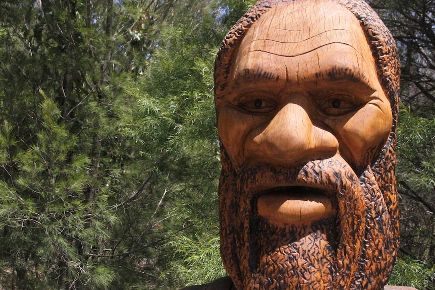 Wooden carved statue of an Aboriginal Dreaming Gold Jabreen which is also a beehive