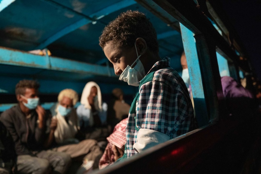 Tigray refugees who fled the conflict in Ethiopia wait on a bus transporting them