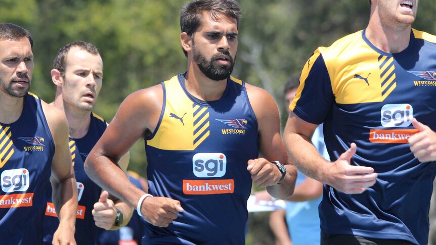 Lewis Jetta is seen running in a time trial wearing a West Coast Eagles tank top surrounded by teammates.