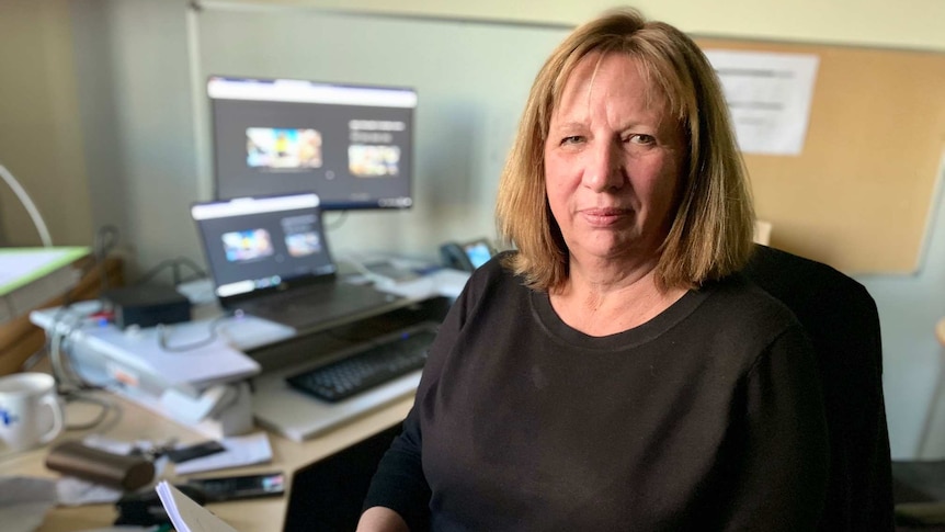 Professor Sandra van der Laan sits in front of her computer in her office.