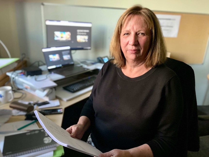 Professor Sandra van der Laan sits in front of her computer in her office.