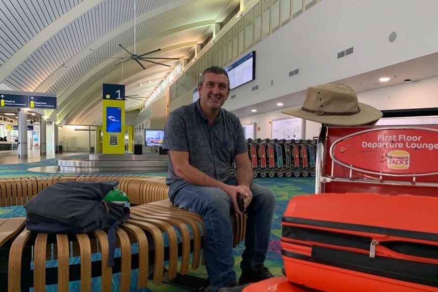 A photo of a man at an airport.