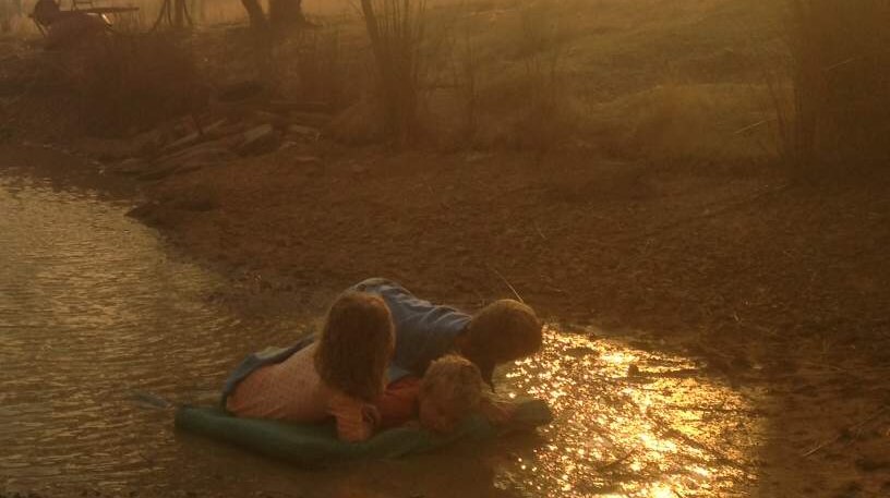 Helen Goudy's three children huddle on matt