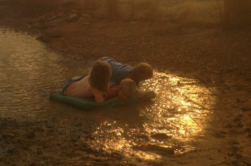 Helen Goudy's three children huddle on matt