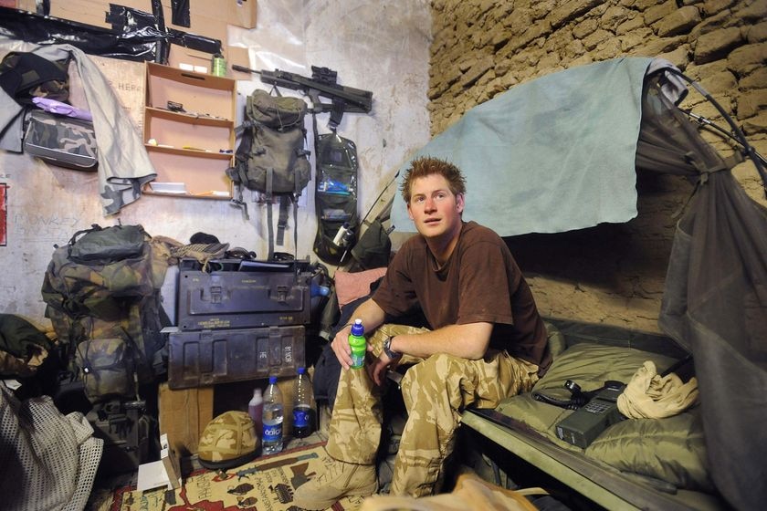 Prince Harry sits in a dugout in Afghanistan