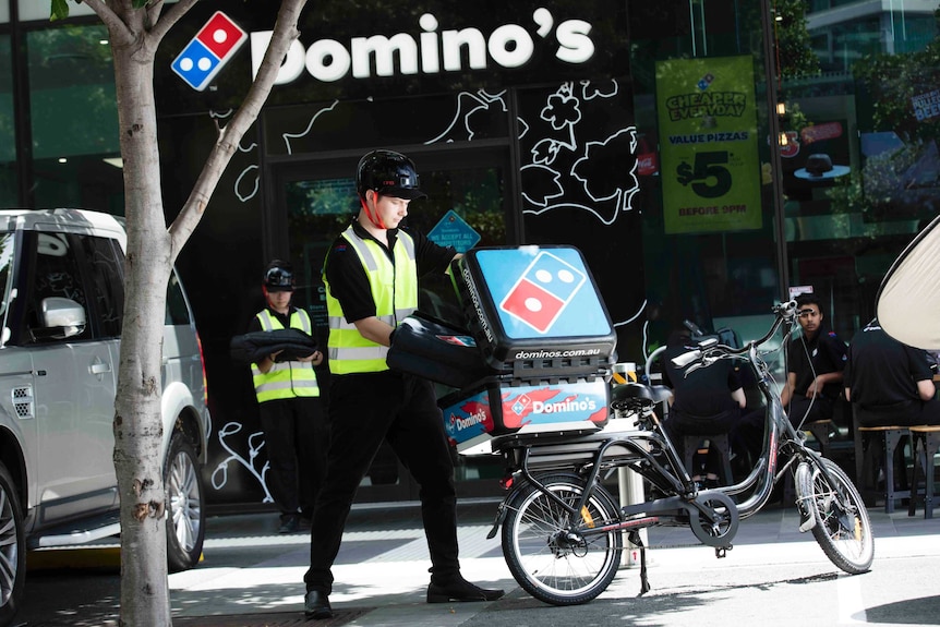 Dominos Pizza store with delivery bicycle outside
