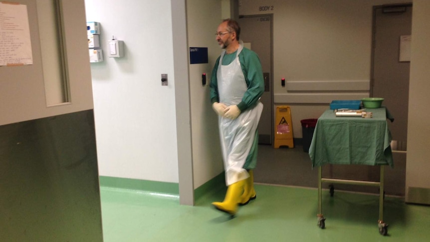 Forensic pathologist David Ranson enters the 'stage' for a performance of The Rest In Silence