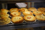 Selection of freshly baked meat pies in bakery.