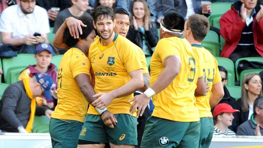 Wallabies players congratulate Henry Speight after his try.