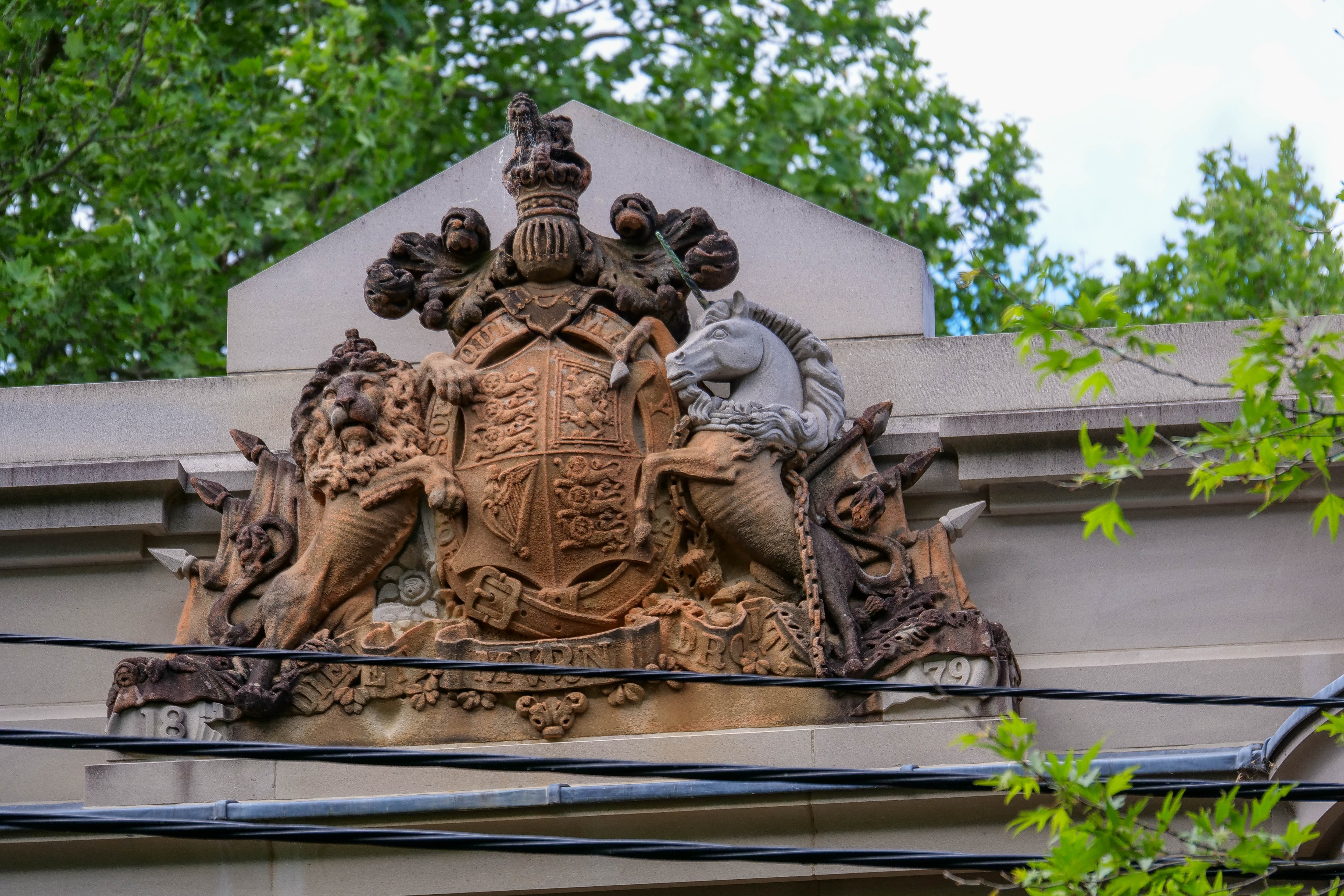 a sandstone coat of arms that includes a grey unicorn head