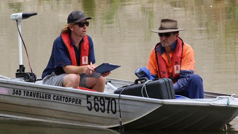 Two fisheries officers on a dinghy on the Barwon-Darling record fish movements.