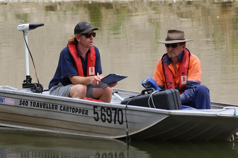 Two fisheries officers on a dinghy on the Barwon-Darling record fish movements.