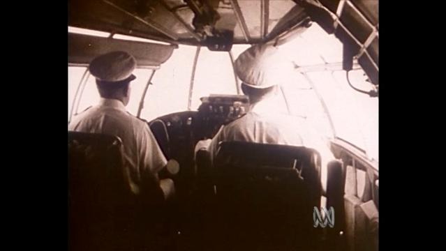 Old photo of pilots in aircraft cockpit