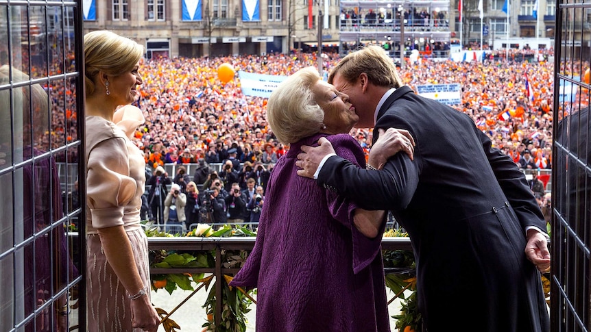 King Willem-Alexander kisses his mother, Beatrix.