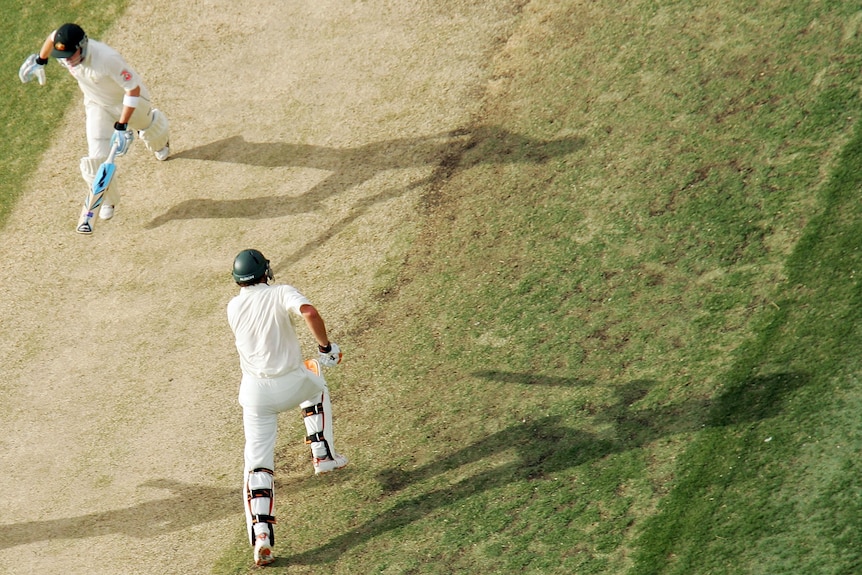 Australian cricketers Michael Clarke and Adam Gilchrist run between the wickets during day three of the third Ashes Test in 2006